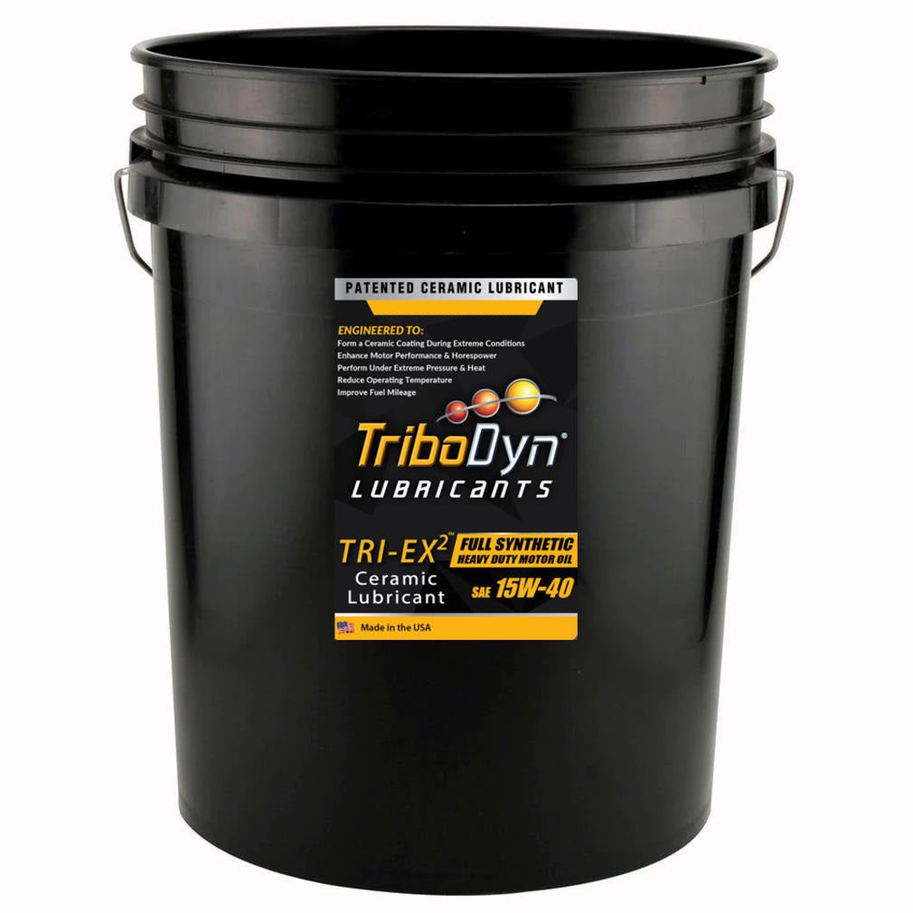 A black five gallon bucket with a label for TriboDyn 15W-40 Full Synthetic Heavy Duty Diesel Engine Oil with ceramic coating