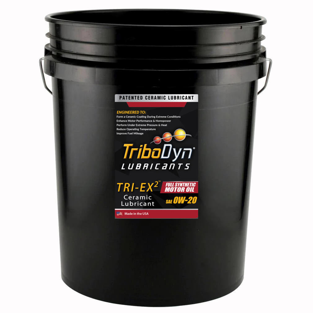 A black 5 gallon pail with a label for TriboDyn 0W-20 TRI-EX2 Full Synthetic Motor with ceramic coating